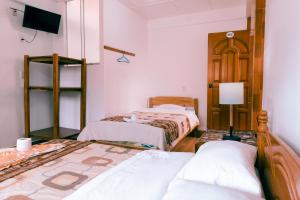Cama o camas de una habitación en Hostal Mi Peru