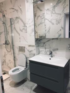 a bathroom with a toilet and a sink and a mirror at Lea in Paris