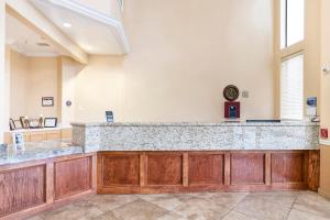 a large lobby with a large marble counter top at OYO Hotel Stafford TX I-69 North in Stafford