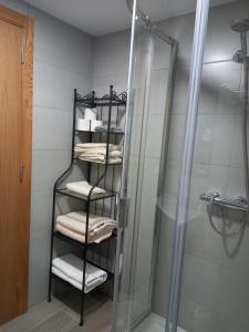 a towel rack in a bathroom with a shower at O Trancallo in Viana do Bolo