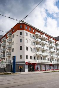 a large white apartment building on the side of a street at Wolkerovka Apartment 1 in Olomouc