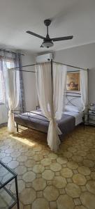 a bedroom with a bed with a ceiling fan at B&B A'la Funtäna in Castiglione di Ravenna