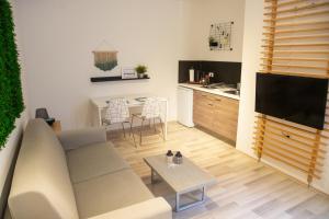 a living room with a couch and a table at Rooms & Apartments La Casa di Loreto in Rovinj