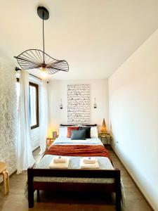 a bedroom with a large bed and a chandelier at Rooms & Apartments La Casa di Loreto in Rovinj