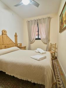 a bedroom with a large bed and a window at VILLA BASILIO in Constantina