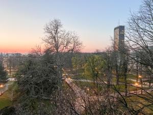 a view of a city at sunset with trees at Manjež Centar in Belgrade