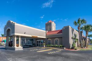 a large office building with a parking lot at Quality Inn Kennedy Space Center in Titusville