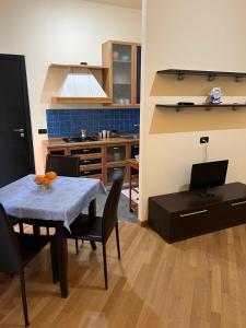 a kitchen and dining room with a table and chairs at Casa Vacanza Adorno in Cefalù