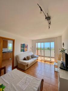 a living room with a couch and a table at house on the beach in Calafell