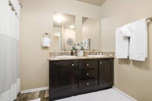a bathroom with two sinks and a large mirror at Wild Cascadia Retreat in Rhododendron +21 photos