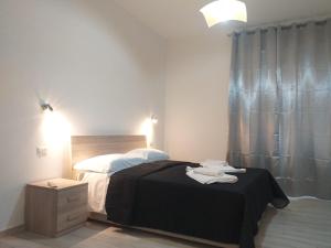 A bed or beds in a room at BERNINI Affittacamere - Guest House