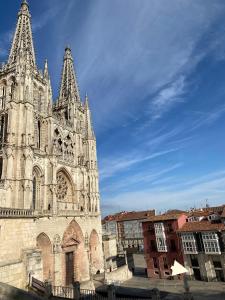 a cathedral with two towers and a blue sky at Puerta al cielo Suite in Burgos