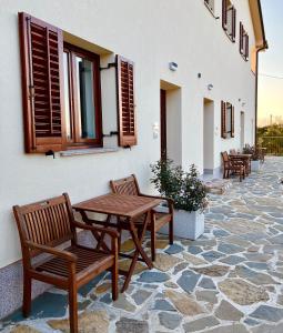 a patio with a wooden table and chairs at Zaro Apartments in Izola