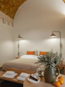 a bedroom with a bed and a table with a cake at San Giovanni Vecchio - Residenza in Matera