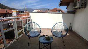 two chairs and a table on a balcony at Pansion Infinity in Mostar