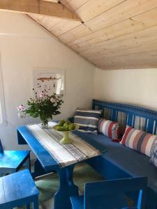 a living room with a blue table and a couch at Seaside Cottage Haga Park in Fröbygårda