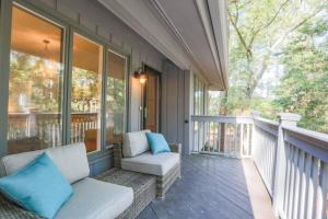 a porch with a white couch and blue pillows at Riverhouse in Johns Island