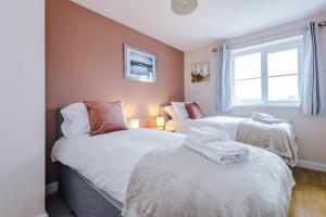1 dormitorio con 2 camas y ventana en Relaxing 3 Bedroom Chester Home with garden, en Broughton