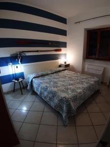 En eller flere senger på et rom på Bilocale Casa Azzurra