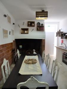 a dining room with a table and a fireplace at Casa da Livraria - Boutique da Cultura in Avis