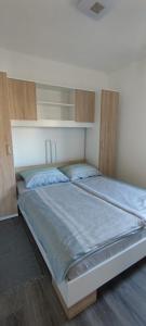 una camera con un grande letto e armadi in legno di Apartman Lynx on lake Sabljaci a Ogulin
