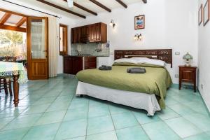 a bedroom with a large bed and a kitchen at Lauricella Bed and Breakfast in Lipari
