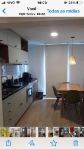 a picture of a kitchen with a table and a dining room at VN CASA TOPÁZIO - VILA MARIANA in Sao Paulo