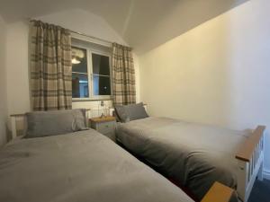 Postel nebo postele na pokoji v ubytování Abbey Cottage