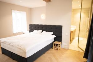 a bedroom with a large bed and a shower at La Rose du Cèdre in Gray