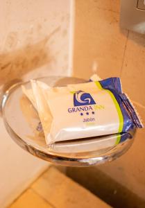 a glass bowl with a package of granddad inn butter at Hotel Granda Inn in Tuxtla Gutiérrez