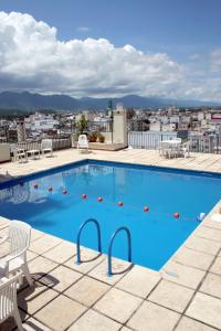 a swimming pool on the roof of a building at Provincial Plaza Hotel in Salta