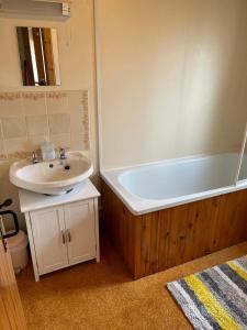 a bathroom with a sink and a bath tub at The Old Ferryhouse in Port Appin