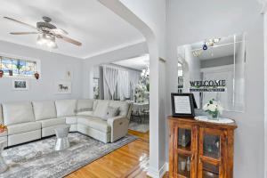 a living room with a white couch and a table at Casa de Paz - Destination to American Dream Mall, NYC, Washington Heights in North Bergen