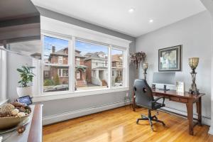 a home office with a desk and a large window at Casa de Paz - Destination to American Dream Mall, NYC, Washington Heights in North Bergen