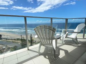 two chairs on a balcony with a view of the ocean at Hi Surf Beachfront Resort Apartments in Gold Coast