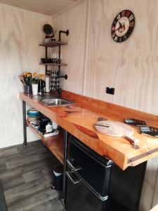 a kitchen with a wooden counter top and a sink at Glenavys Waitaki River Motor Camp in Glenavy