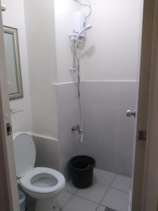 een witte badkamer met een toilet en een douche bij Urban Deca Tower EIMYS PLACE 3 in Manilla