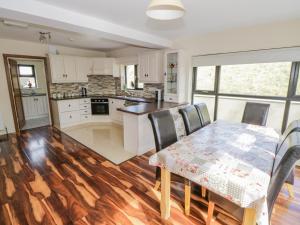 a kitchen with a table and a table and chairs at Hannon's Country Farmhouse in Ballymote