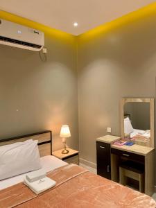 Postel nebo postele na pokoji v ubytování Al Rawdha Hotel Apartments