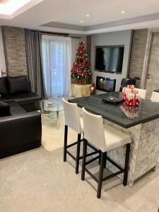 a living room with a christmas tree and a table and chairs at Evelina’s house in Neochorópoulon