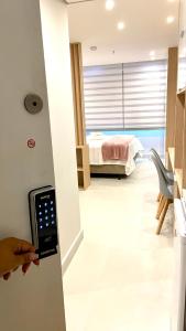 una persona está abriendo una puerta a un dormitorio en Estudio Em Itaipava - Granja Brasil - Flat Luxo - Com Piscina Aquecida, en Itaipava