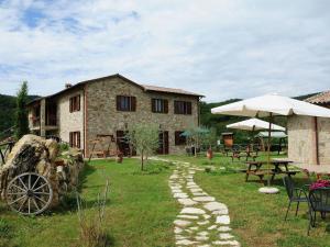 a stone path in front of a building at Farmhouse with small lake swimming pool private terrace garden and sheep in Passignano sul Trasimeno