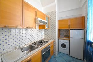 a kitchen with a sink and a stove top oven at Dolce Vita A in Amalfi