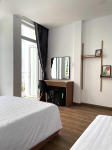 a hotel room with a bed and a television at Airport homestay in Da Nang