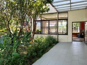 an office building with a courtyard with trees and plants at Li Quan Hot Spring Resort in Baihe