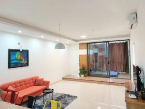 a living room with a couch and a window at Pooh House 7 - 3 bedrooms with city view in Vung Tau