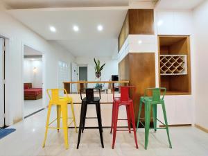 un grupo de taburetes coloridos en una cocina en Pooh House 7 - 3 bedrooms with city view, en Vung Tau