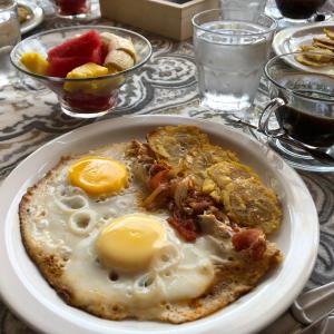 a plate of food with eggs on a table at Hotel Refugio Cariguana in Valle de Anton +70 photos