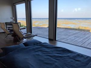 a living room with a view of the ocean at ゴールデンマイルヴィラ in Amami