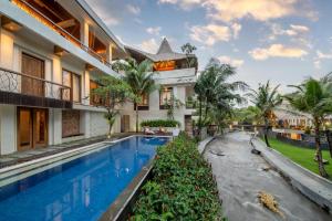 an exterior view of a villa with a swimming pool at Harsono Boutique Resort Bali in Gianyar